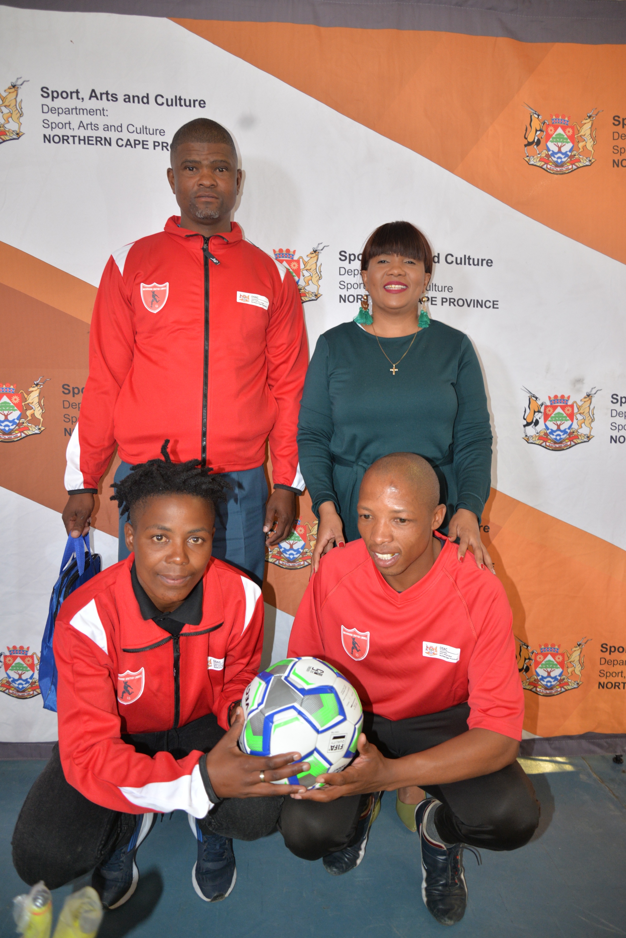 back from left to right Armichand Amsterdam ( Owner of the Club) MEC for Sport , Arts and Culture Ms Bernice Sinxeve front from left to right Noxolo Nongxuso (captain ) and Tshupo Mogajane ( Coach)
